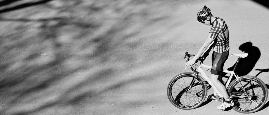 Black and White Image of Man on Bike